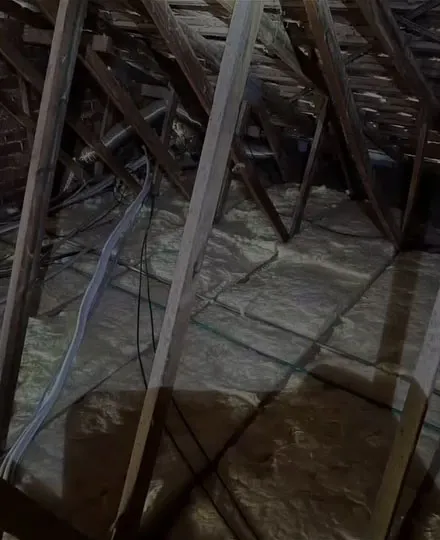 Insulation batts laid between timber roof trusses in a ceiling space