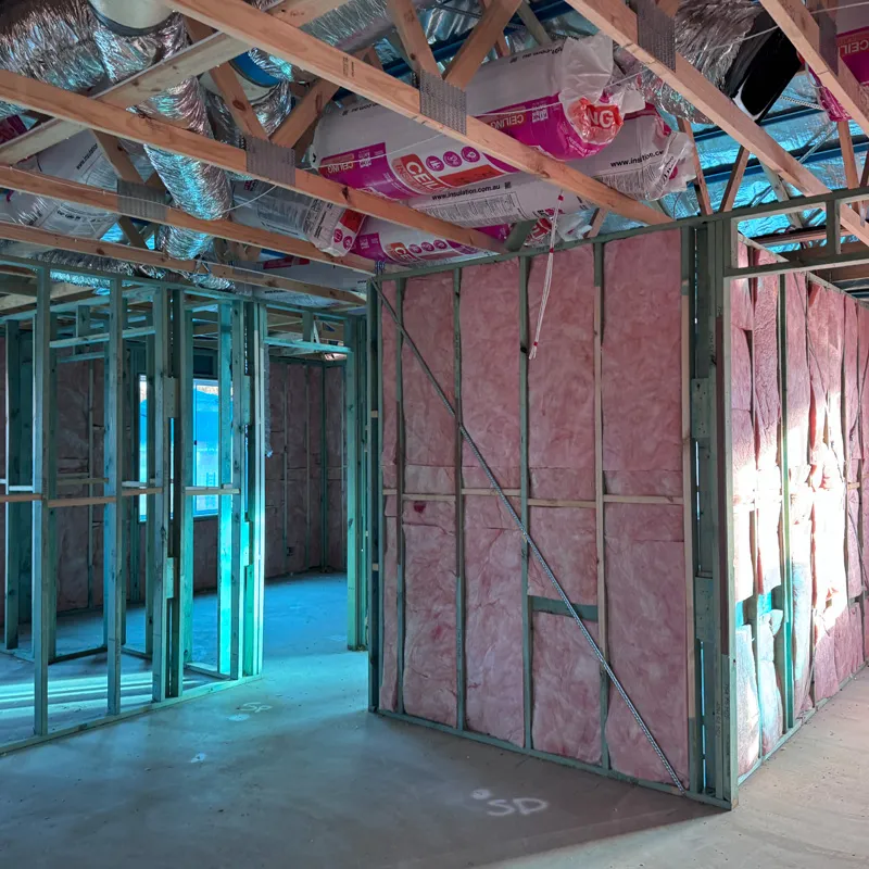 Pink wall batts in steel-framed walls of a new home under construction