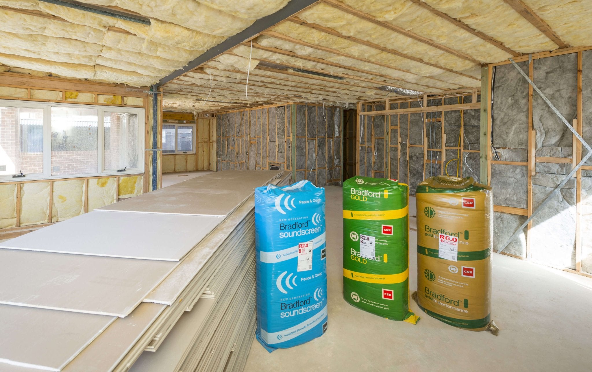 Bradford Soundscreen and Bradford Gold insulation packs in a room with insulated walls