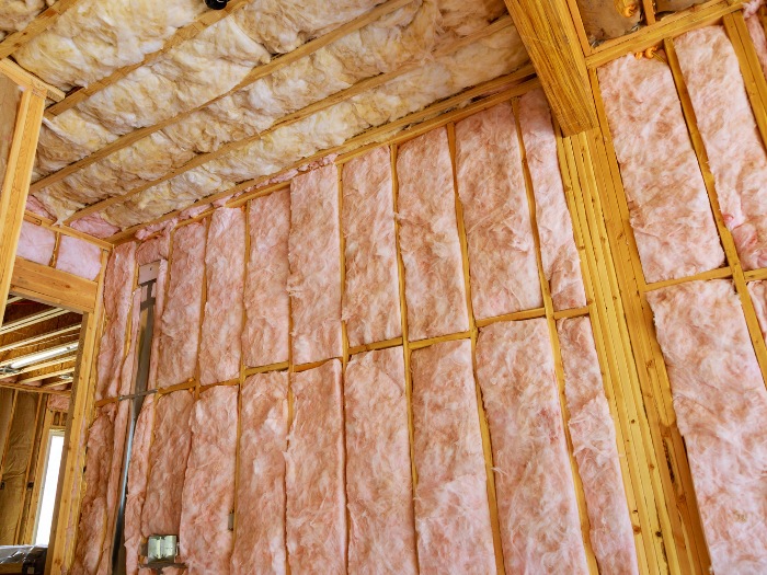 wall insulation installation Albury–Wodonga Pink insulation batts in the walls and ceiling of a timber-framed room