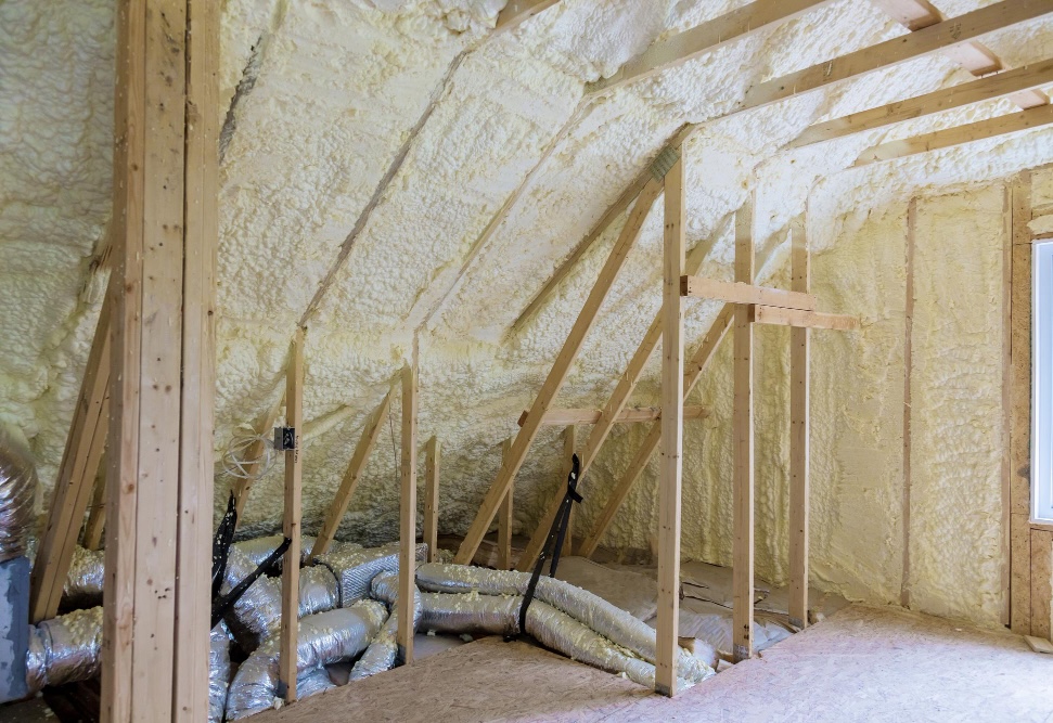 Local North East Insulation Wangaratta Spray foam insulation under a sloping roof, with ducting on the attic floor