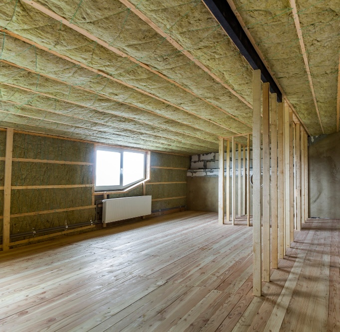 Wall Insulation service Bright Attic room with mineral wool insulation between the ceiling rafters